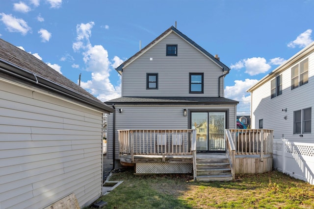 rear view of house with a yard and a wooden deck