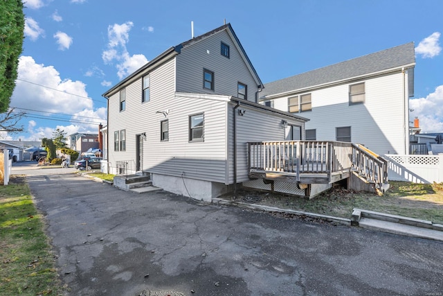 rear view of house featuring a deck