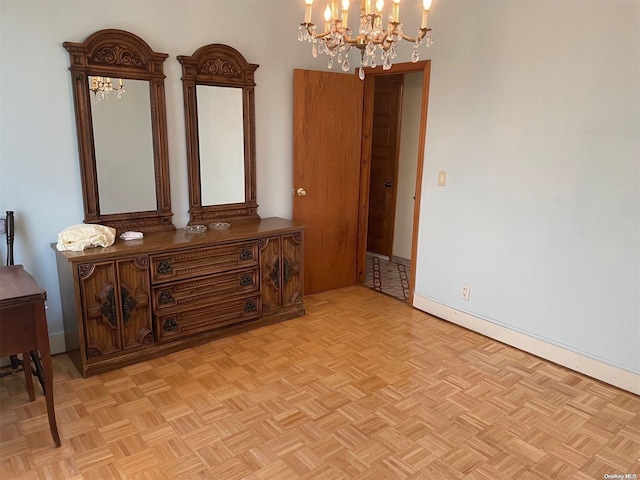 interior space featuring light parquet floors and a chandelier