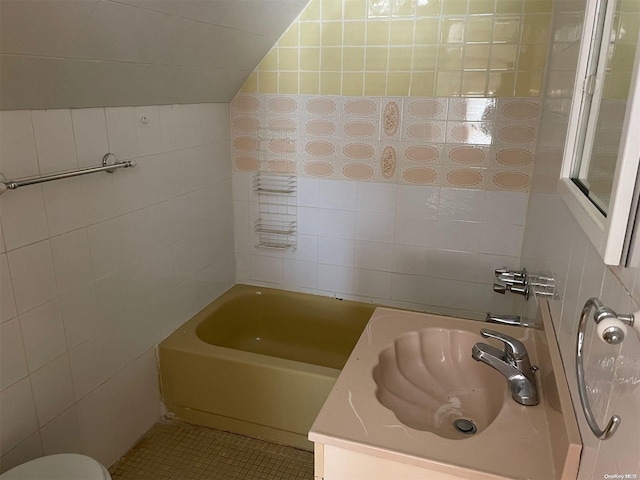 bathroom featuring tile patterned flooring, vanity, and tile walls