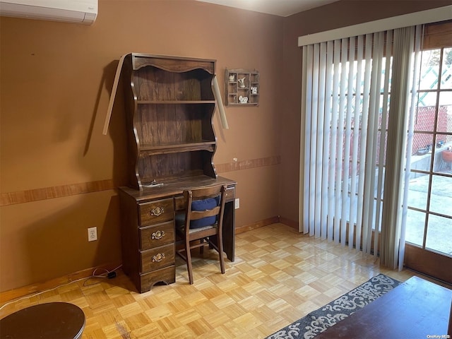 office with a wall mounted air conditioner and light parquet flooring