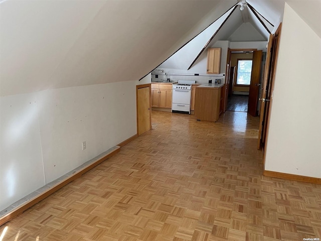 bonus room featuring sink, light parquet floors, and lofted ceiling