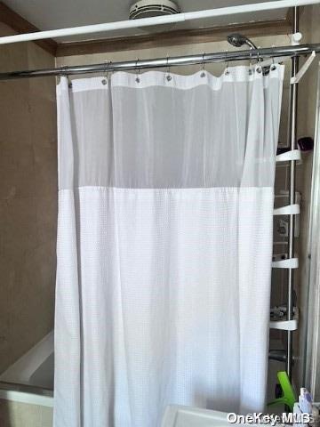 bathroom with a shower with curtain