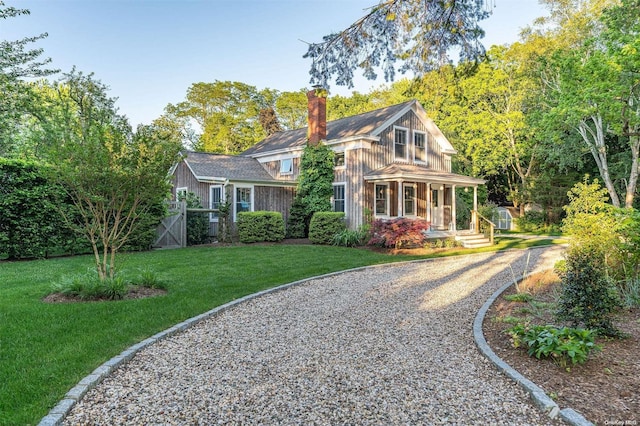 view of front of property with a porch and a front lawn