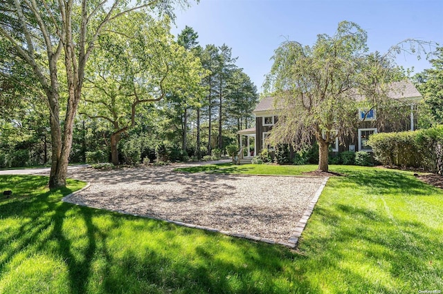 view of home's community featuring a lawn