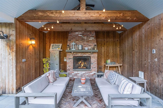 living room featuring wood walls, lofted ceiling with beams, and an outdoor brick fireplace