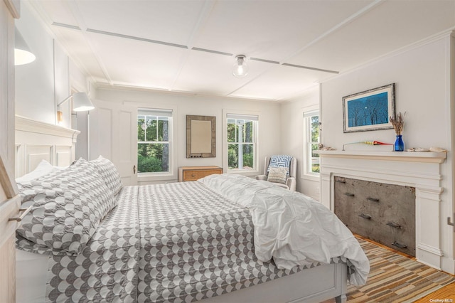 bedroom with wood-type flooring and crown molding