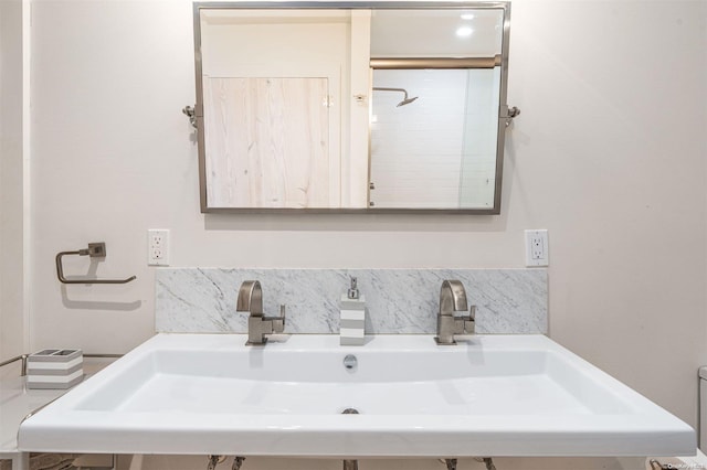 bathroom with backsplash and sink