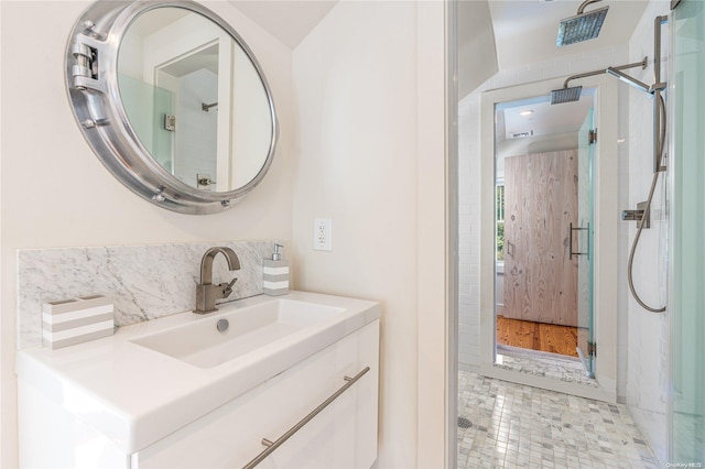 bathroom with tile patterned floors, a shower, and vanity