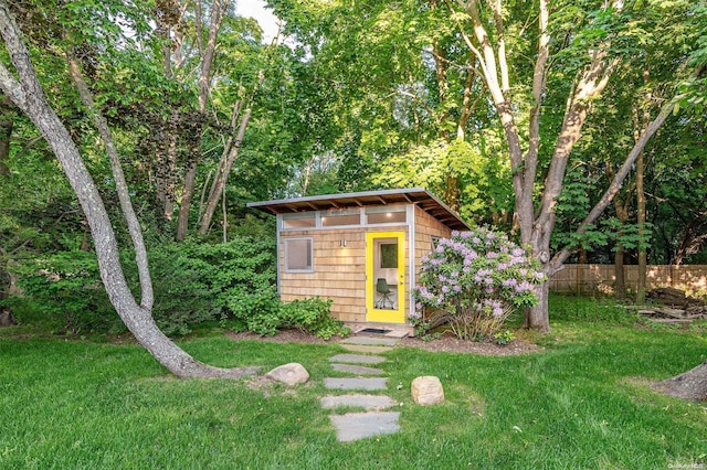 view of outbuilding featuring a yard