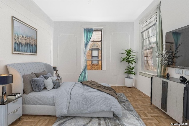 bedroom with light parquet flooring