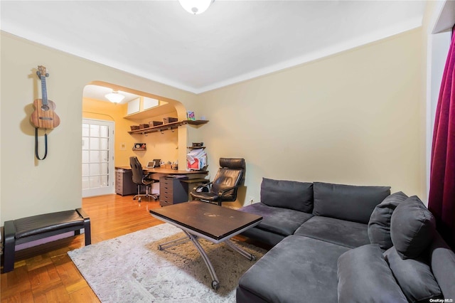 41-12 41st St Unit 3-H, Sunnyside, NY 11104 - living room featuring arched walkways, a desk, and light wood-style floors
