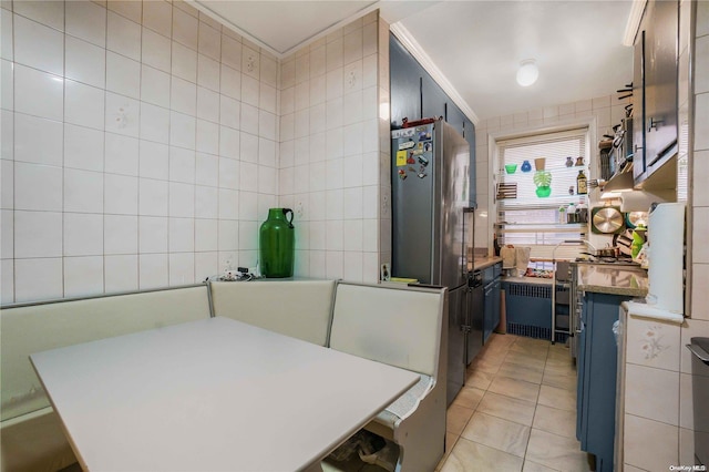 41-12 41st St Unit 3-H, Sunnyside, NY 11104 - kitchen featuring freestanding refrigerator, light tile patterned flooring, tile walls, blue cabinets, and radiator
