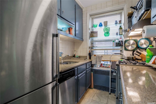 41-12 41st St Unit 3-H, Sunnyside, NY 11104 - kitchen featuring appliances with stainless steel finishes, a sink, radiator, blue cabinetry, and decorative backsplash