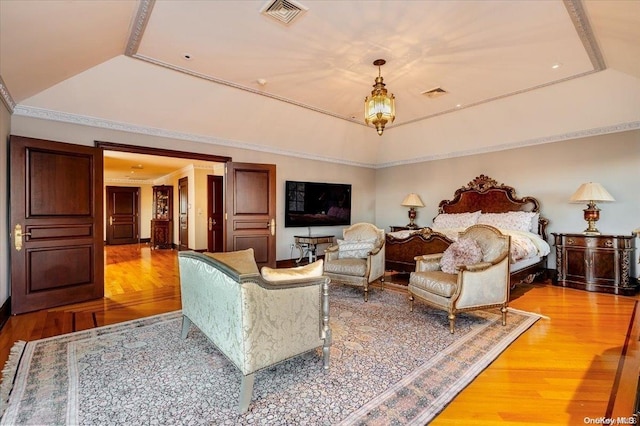 bedroom featuring hardwood / wood-style flooring and a tray ceiling