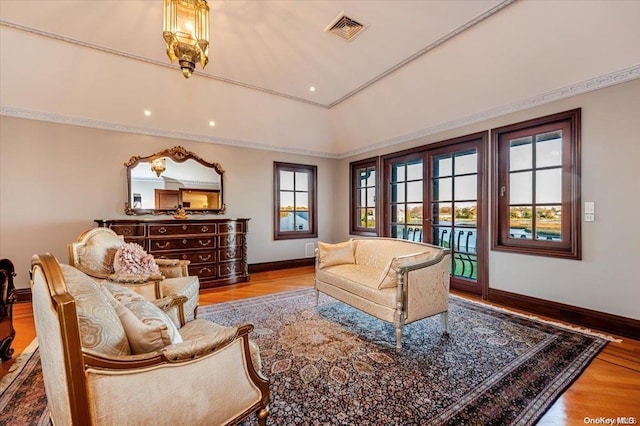 living room with a healthy amount of sunlight, light wood-type flooring, and french doors