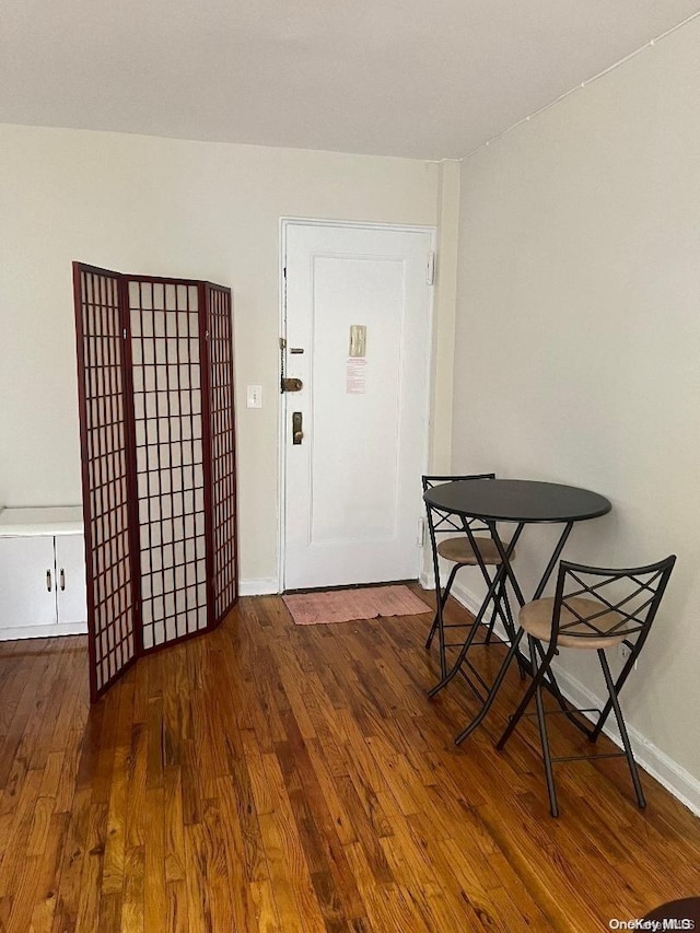 dining area with dark hardwood / wood-style floors