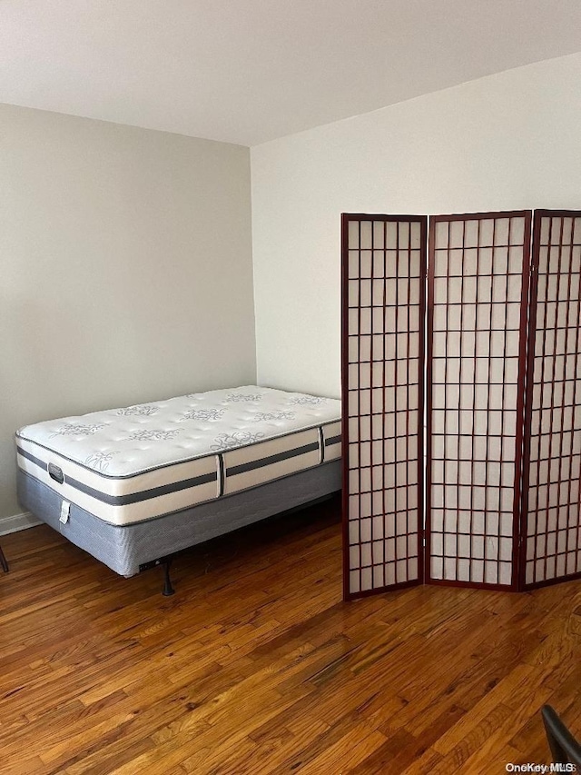 bedroom featuring dark hardwood / wood-style flooring