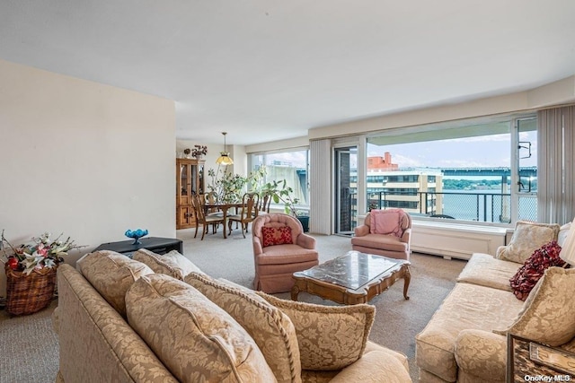 living room featuring light colored carpet and a water view