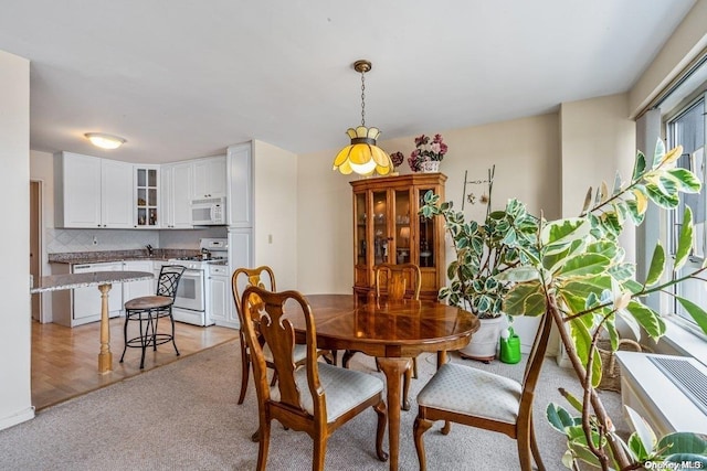 dining space featuring sink and light hardwood / wood-style flooring