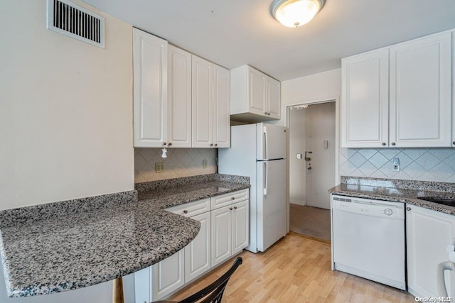 kitchen with light hardwood / wood-style flooring, white cabinets, and white appliances