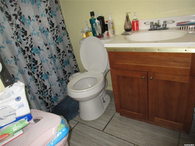 bathroom featuring a shower with curtain, vanity, and toilet