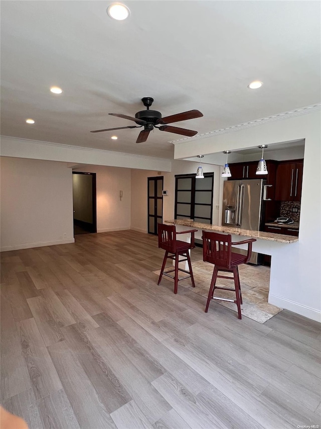 dining area with ceiling fan and light hardwood / wood-style flooring