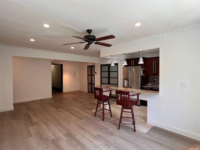 dining area featuring ceiling fan, crown molding, and light hardwood / wood-style flooring