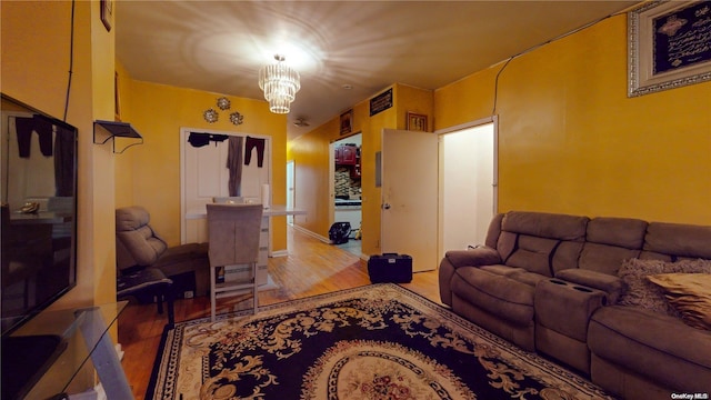 living room featuring light wood-type flooring and an inviting chandelier