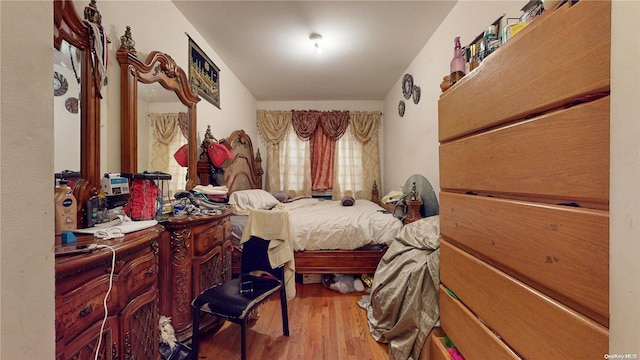 bedroom with hardwood / wood-style flooring