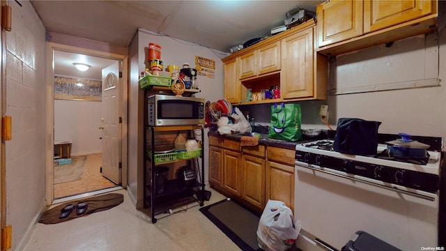 kitchen featuring white range with gas cooktop