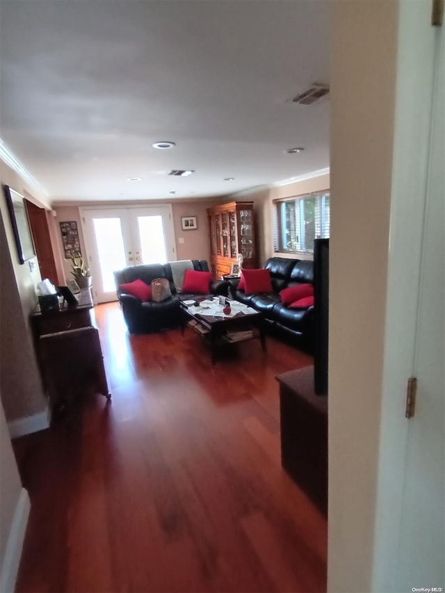 living room featuring crown molding, french doors, and hardwood / wood-style floors