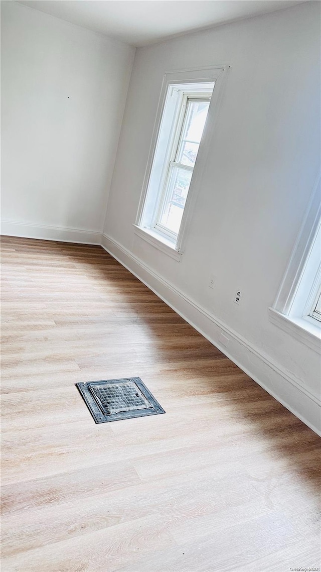 empty room with light hardwood / wood-style floors