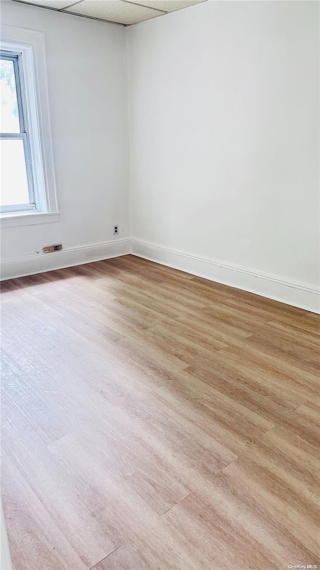 unfurnished room with light wood-type flooring