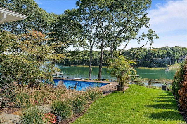 view of pool with a water view and a lawn