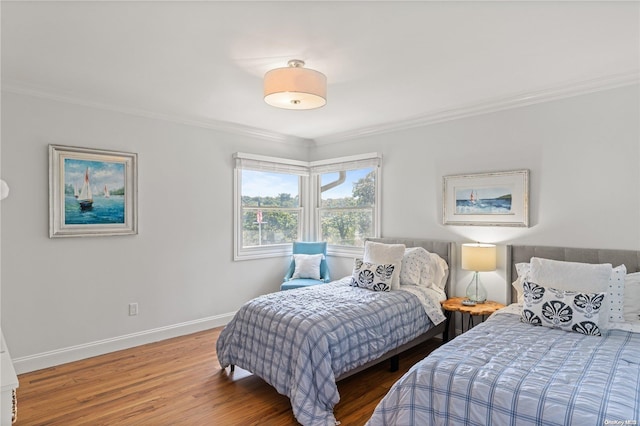 bedroom with crown molding and wood-type flooring