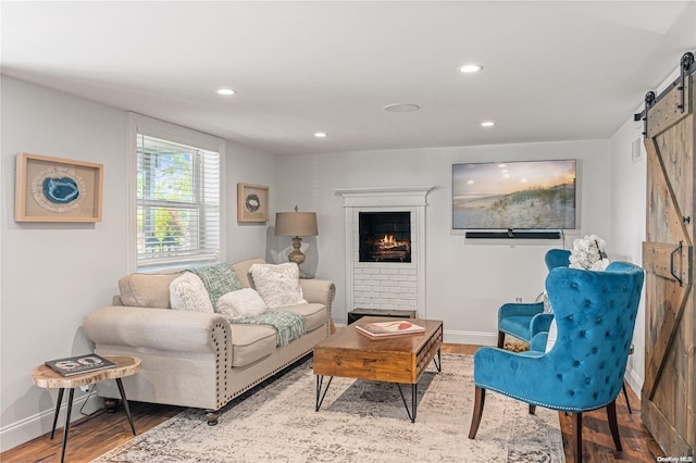 living room featuring hardwood / wood-style floors and a barn door