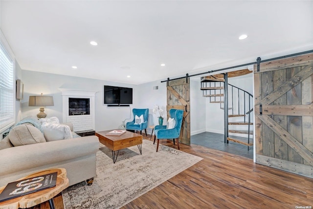 living room featuring hardwood / wood-style flooring and a barn door