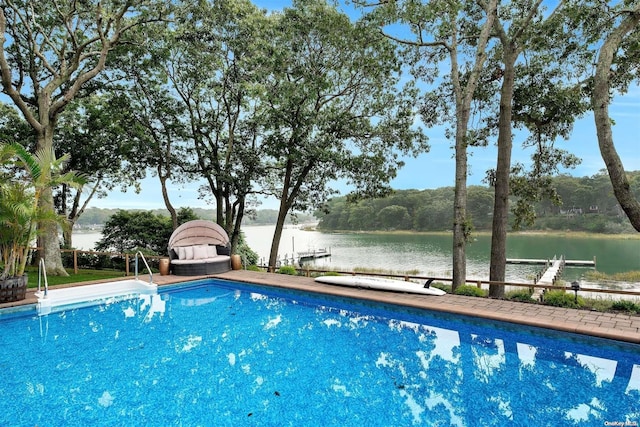 view of swimming pool featuring a boat dock and a water view