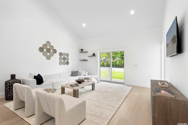 21 Montauk Hwy Unit 5, Westhampton, NY 11977 - living room featuring light wood-type flooring, high vaulted ceiling, recessed lighting, and baseboards
