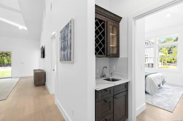 21 Montauk Hwy Unit 5, Westhampton, NY 11977 - indoor wet bar featuring healthy amount of natural light, tasteful backsplash, and light wood-style flooring