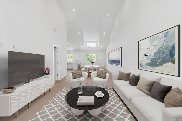 21 Montauk Hwy Unit 9, Westhampton, NY 11977 - living area with high vaulted ceiling, wood finished floors, recessed lighting, and baseboards