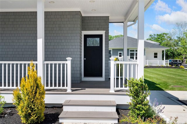 21 Montauk Hwy Unit 9, Westhampton, NY 11977 - entrance to property featuring covered porch and a lawn