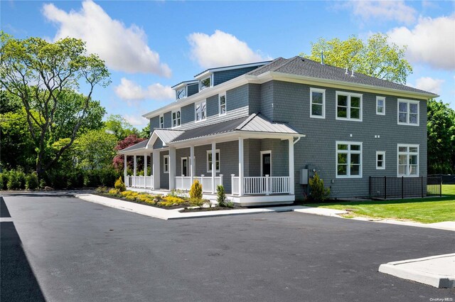 21 Montauk Hwy Unit 9, Westhampton, NY 11977 - view of front facade featuring a porch, metal roof, and a standing seam roof