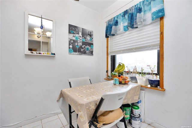 tiled dining space with a notable chandelier