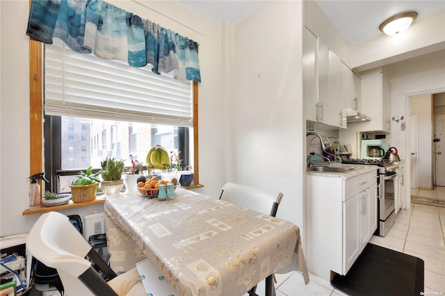 tiled dining area featuring sink