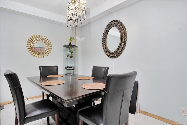 dining room featuring a notable chandelier and light tile patterned flooring