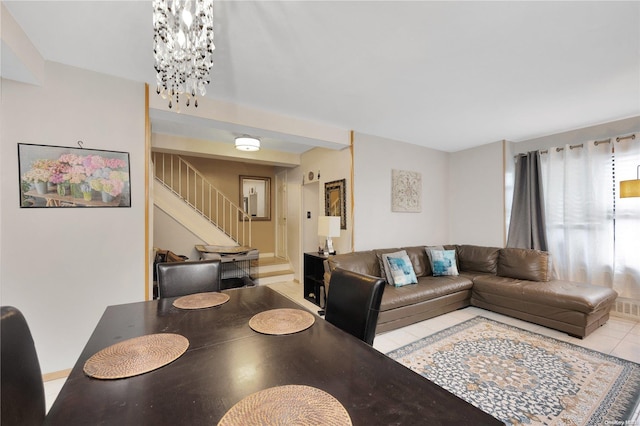 tiled dining area featuring a chandelier