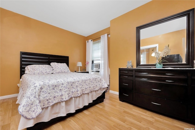 99-40 63rd Rd Unit 9Z, Rego Park, NY 11374 - bedroom with light wood finished floors, baseboards, lofted ceiling, and cooling unit