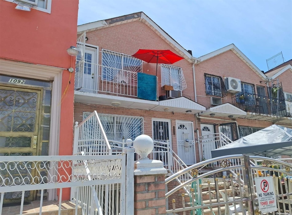 1090 Hancock St, Brooklyn, NY 11221 - view of front of home with a cooling unit, brick siding, and a gate